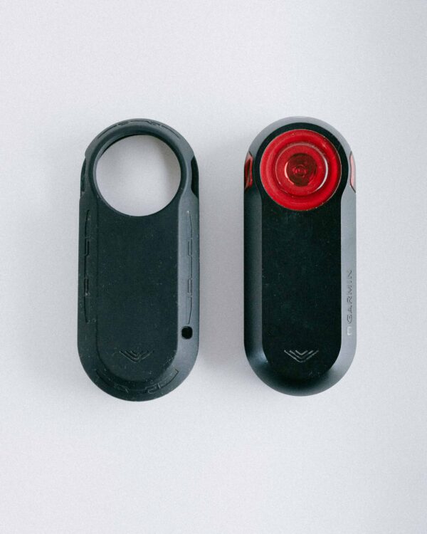A silicone cover on the left and the Garmin Varia rear light on the right, both shown next to each other.