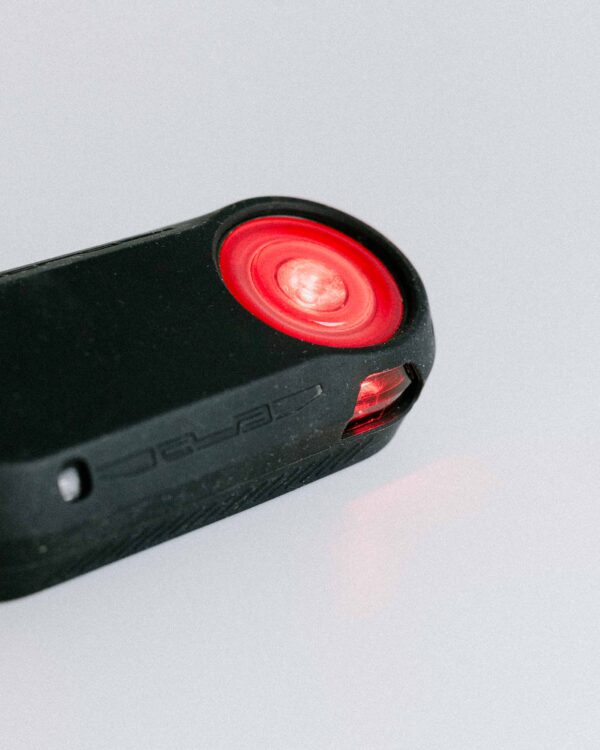 Close-up of the Garmin Varia rear light with red LED and silicone cover.
