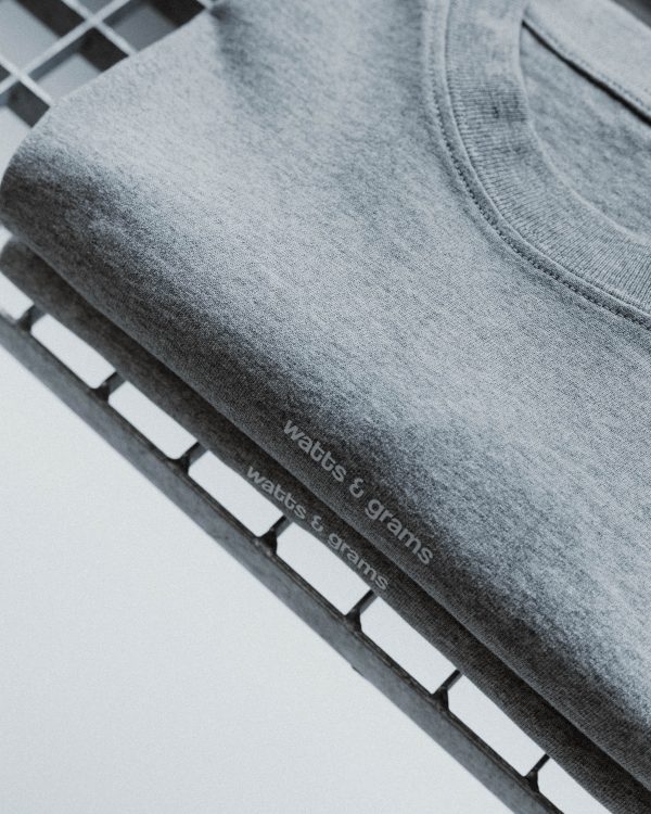 Gray watts and grams logo t-shirt unisex folded with front logo of watts and grams.